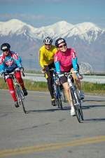 photo of riders with mountains behind